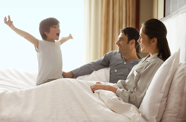 Family waking up in the Sheraton bed